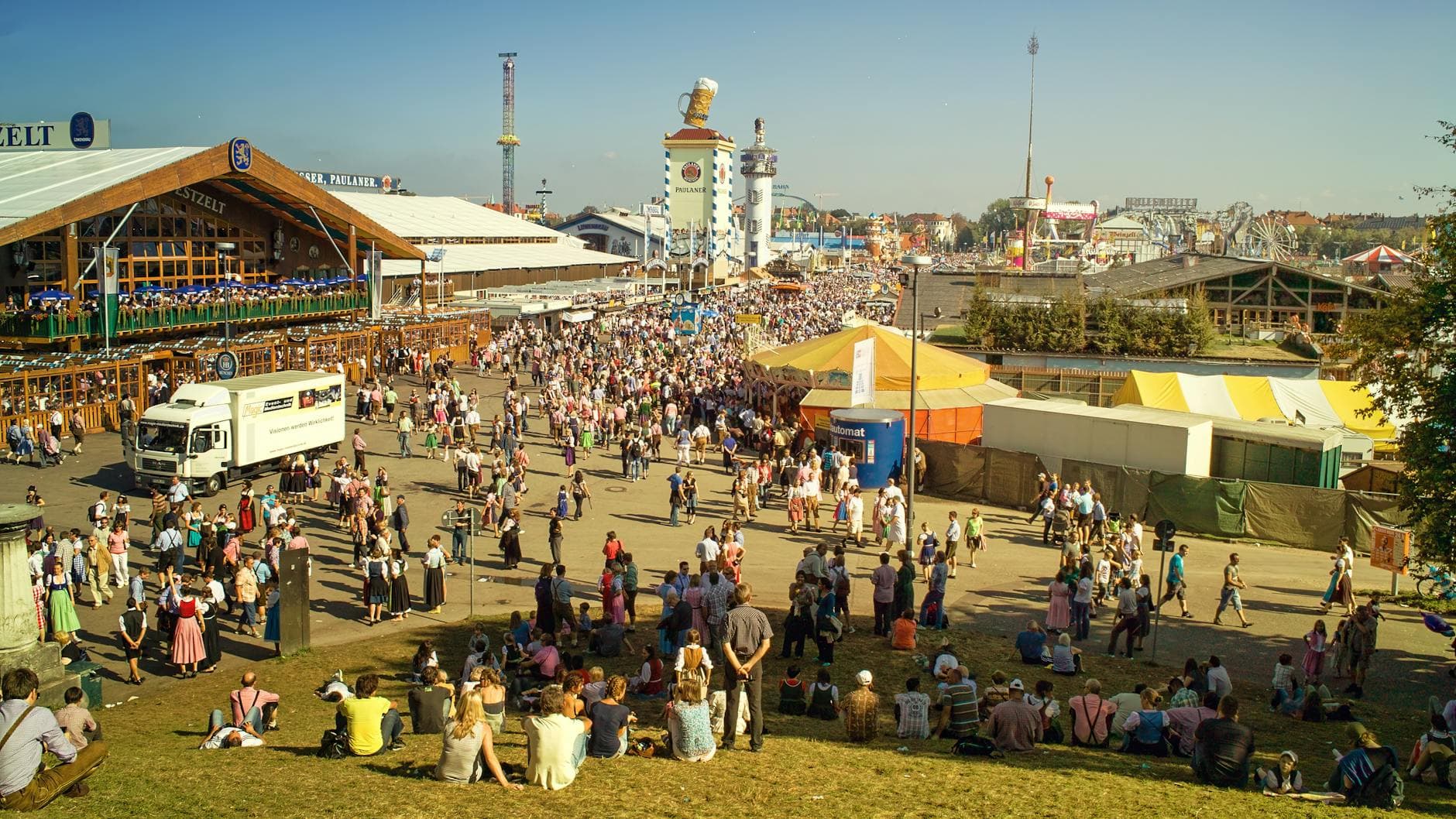 A bustling scene of people gathered at Oktoberfest, Munich, showcasing traditional attire and lively atmosphere.