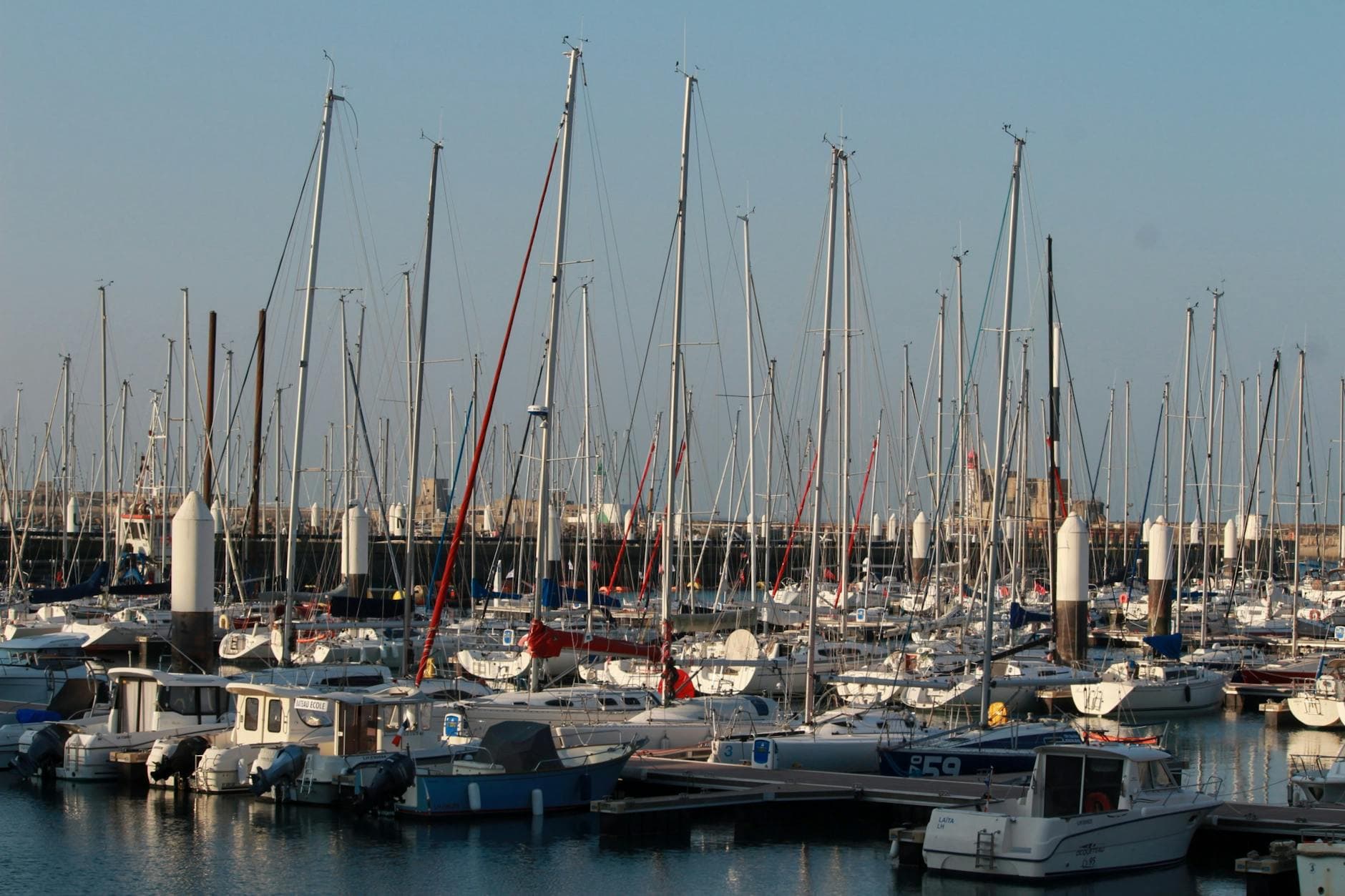 A serene view of sailboats docked at Le Havre Marina in Normandy, France.