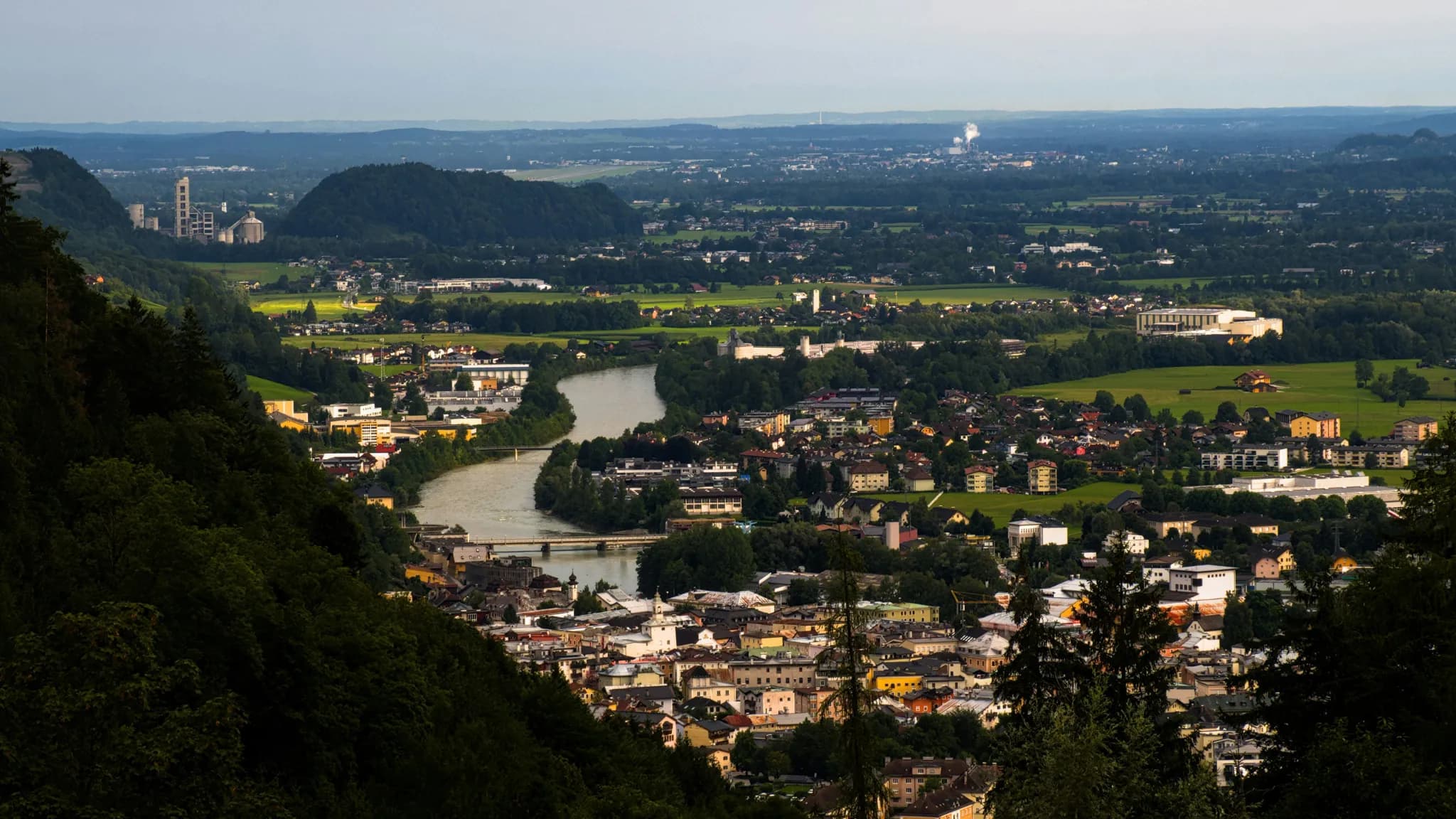 Panoramic view of a city nestled beside a winding river.