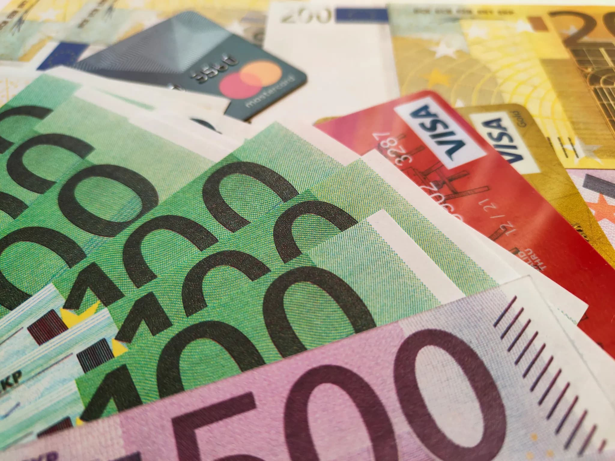 a pile of money with a credit card sticking out of it