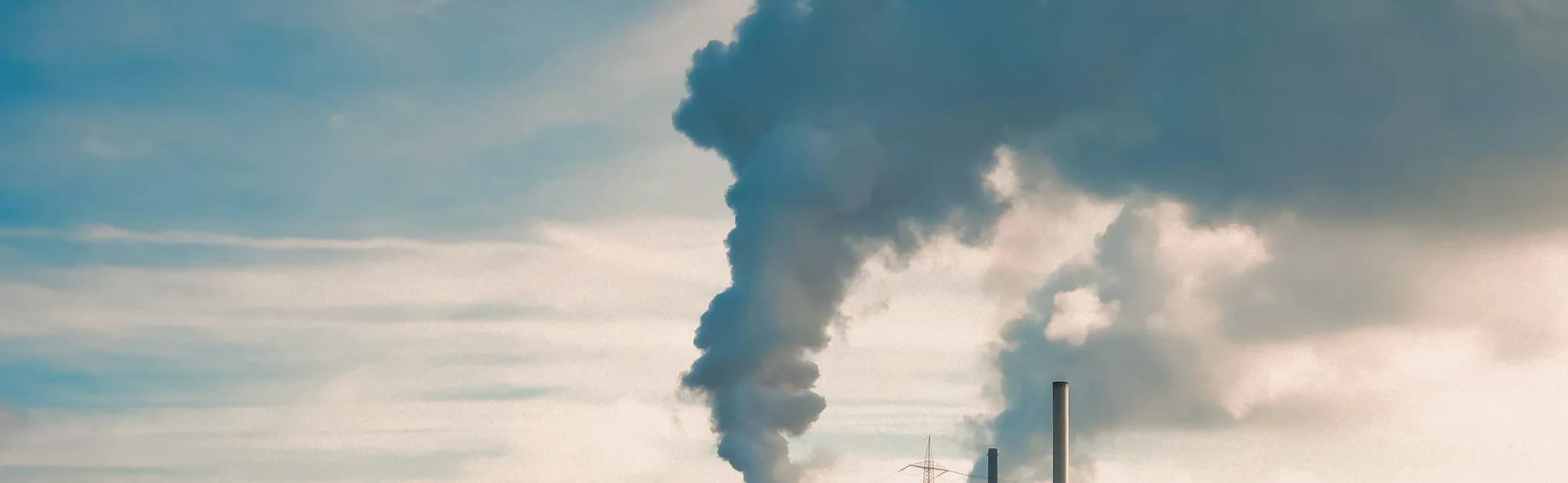 a factory with smoke coming out of it's stacks