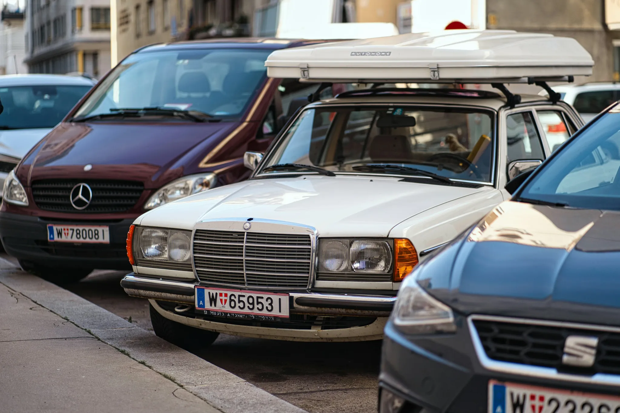 a group of cars parked on the side of a street