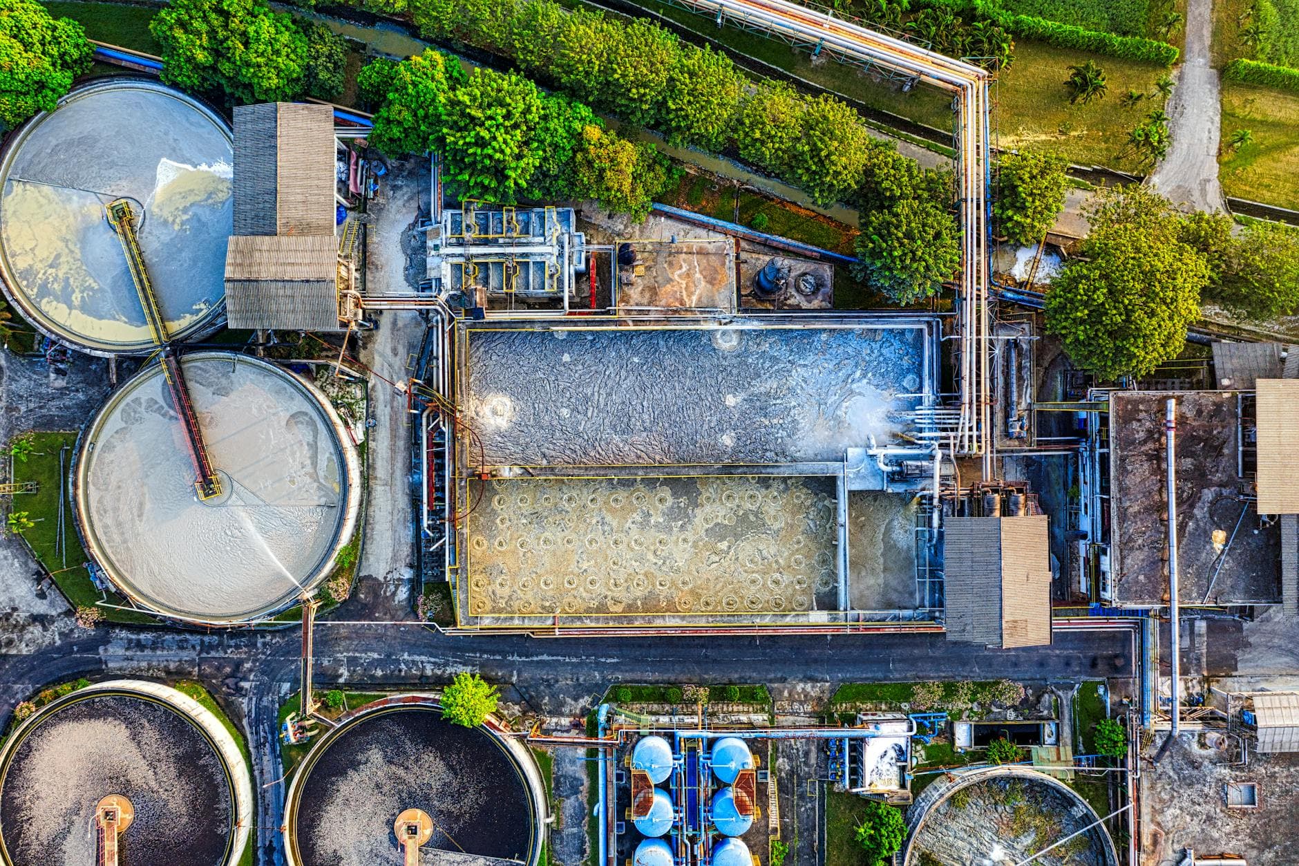 Top-down view of an industrial waste management facility in Serang, Indonesia, highlighting various processing tanks.