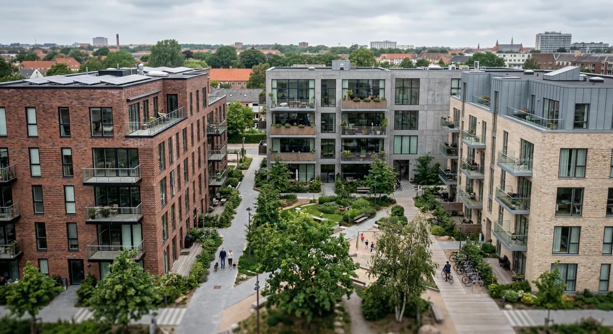A high-angle photorealistic shot of three distinct modern European apartment buildings separated by shared courtyard paths. The scene is captured in soft natural light under an overcast sky, with a sh