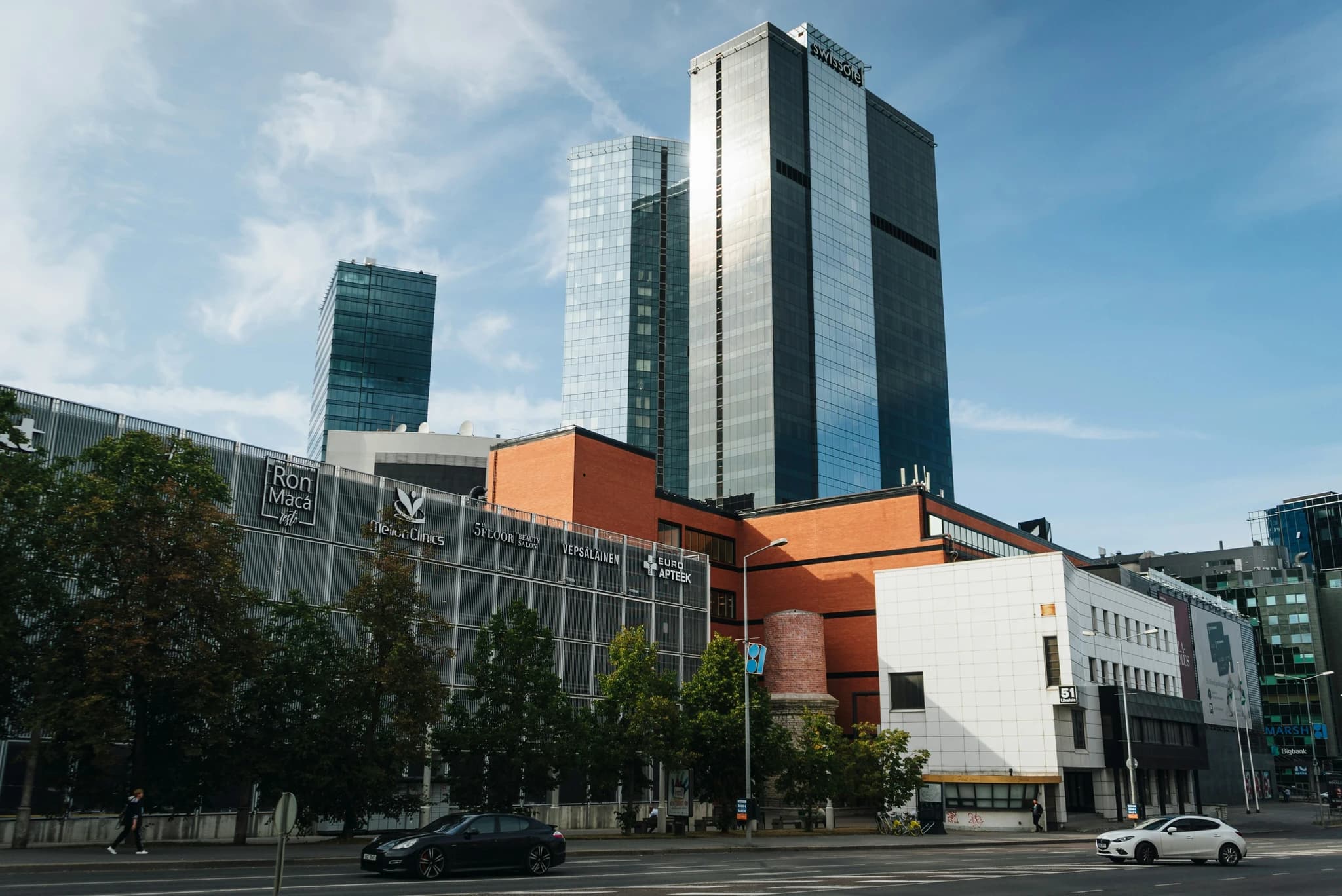 a city with tall buildings and cars on the street