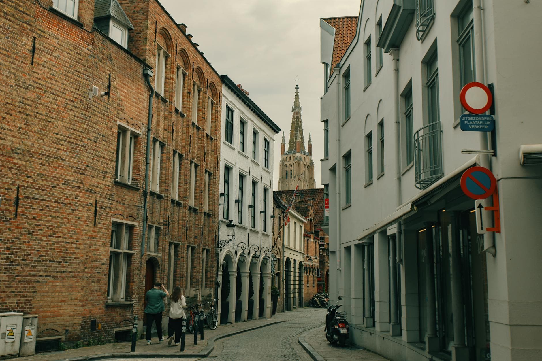 Explore a picturesque, cobblestone street scene in historic Bruges, Belgium, capturing its timeless architecture.